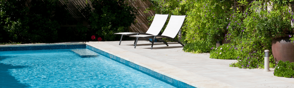 Sparkling blue backyard swimming pool in Fort Worth, Texas maintained by Noah's Pool Service.